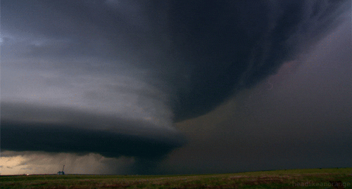 Time-lapse view of a dramatic rotating storm over open fields